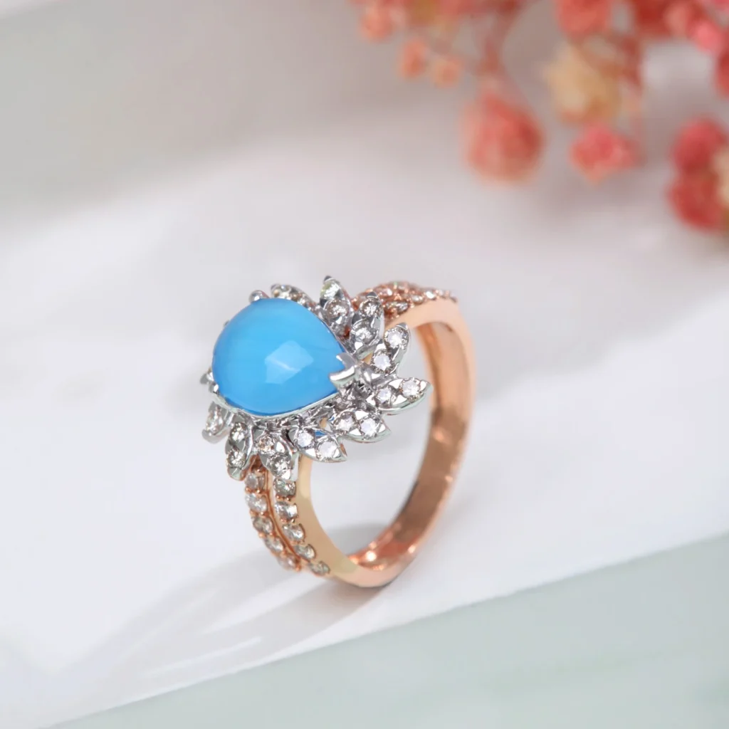 a ring with a blue stone and diamonds