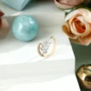 a ring with diamonds and a blue ball